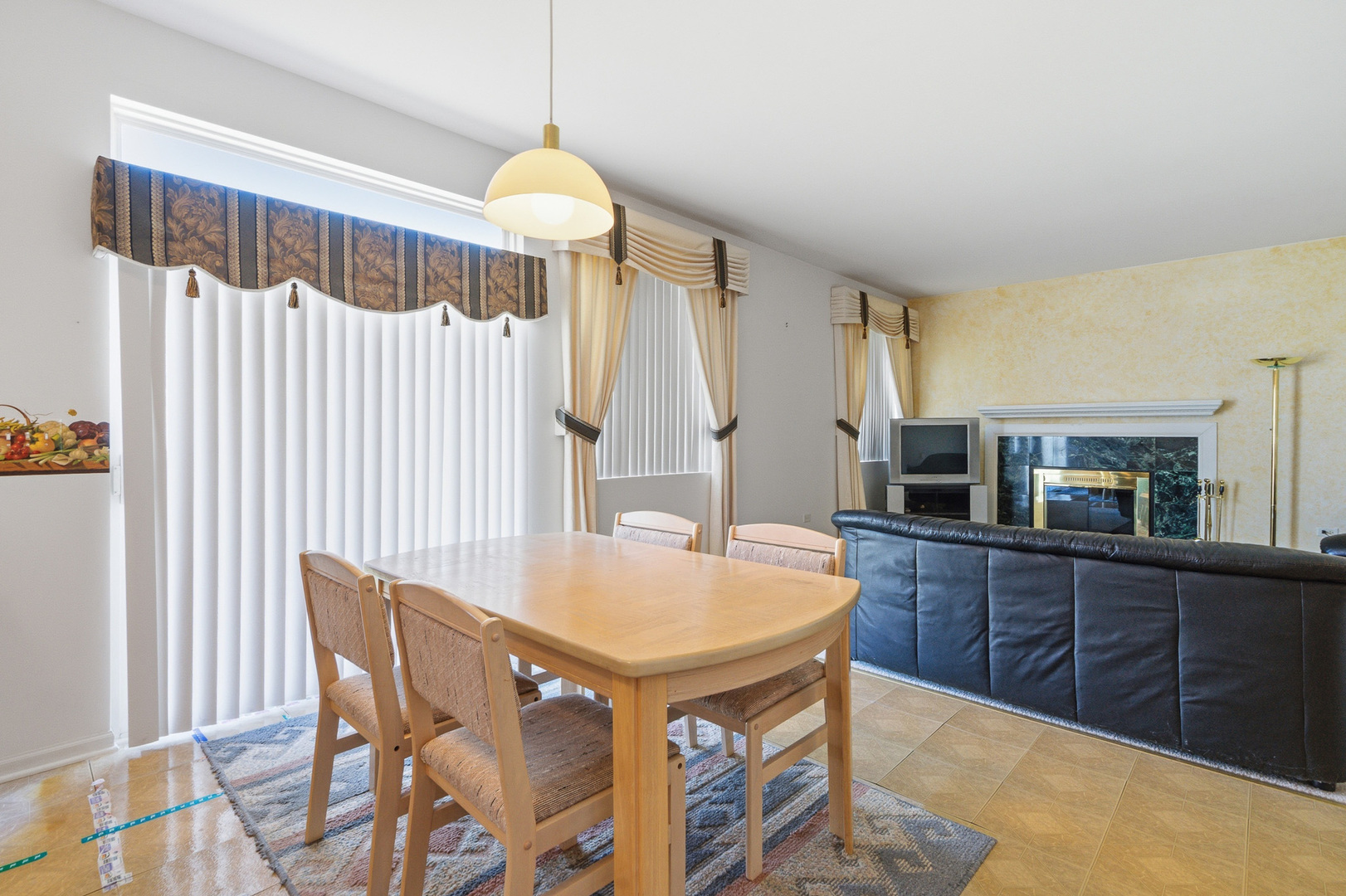 100 Sycamore Drive Bolingbrook, IL 60490 - Photo 11 of 42 a kitchen with granite countertop a table chairs and a wooden floor