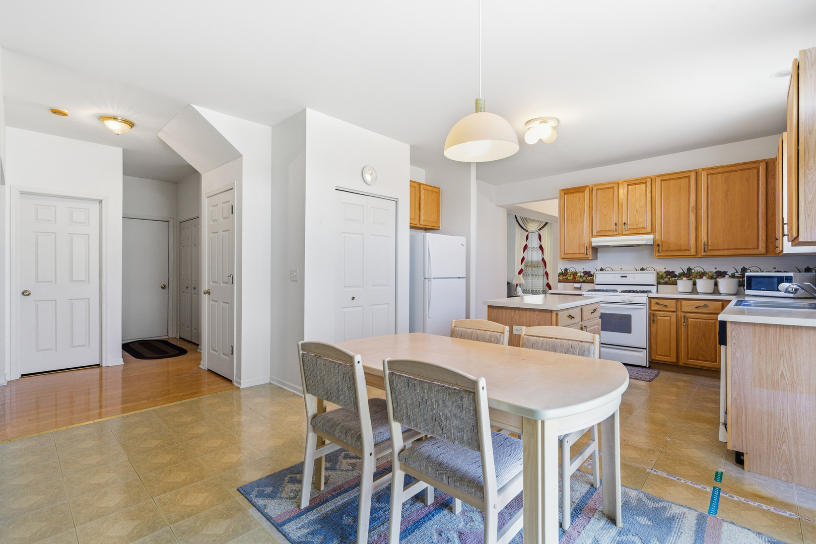 100 Sycamore Drive Bolingbrook, IL 60490 - Photo 12 of 42 a kitchen with granite countertop a sink cabinets stainless steel appliances and a counter top space
