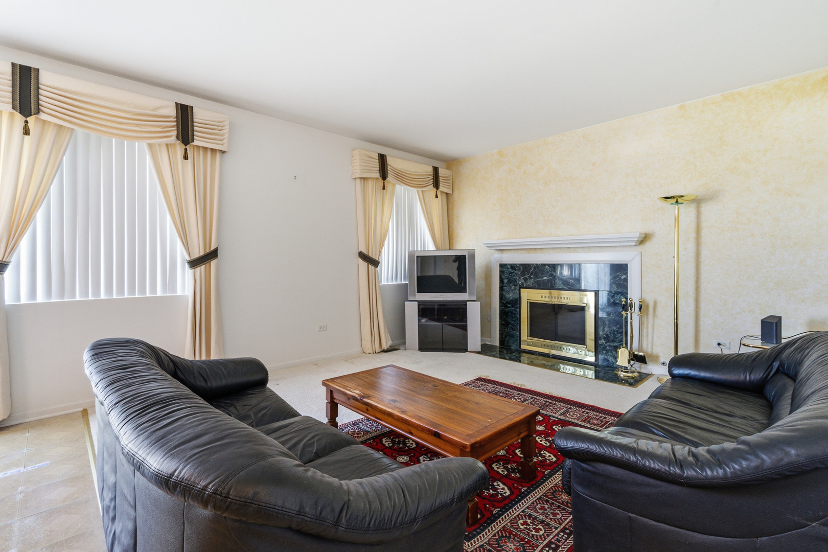 100 Sycamore Drive Bolingbrook, IL 60490 - Photo 16 of 42 a living room with furniture and a fireplace