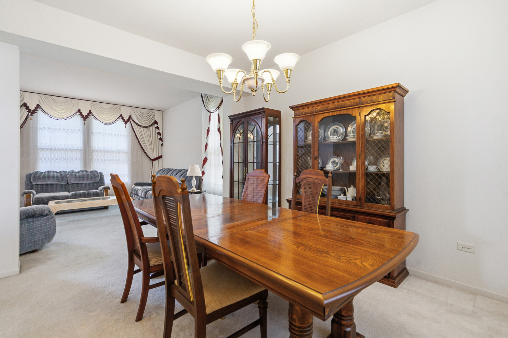 100 Sycamore Drive Bolingbrook, IL 60490 - Photo 6 of 42 a dining room with wooden floor a chandelier a wooden table and chairs