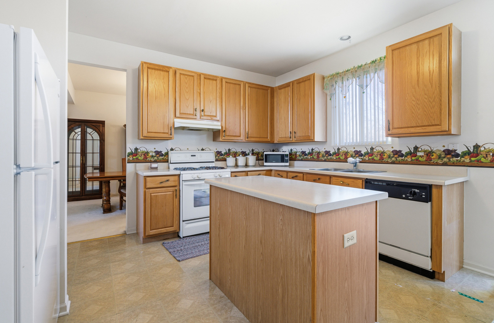 100 Sycamore Drive Bolingbrook, IL 60490 - Photo 7 of 42 a kitchen with a sink stove and cabinets