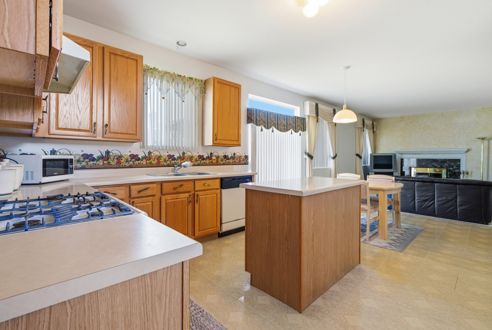 100 Sycamore Drive Bolingbrook, IL 60490 - Photo 8 of 42 a kitchen with stainless steel appliances a stove top oven a sink a refrigerator and cabinets