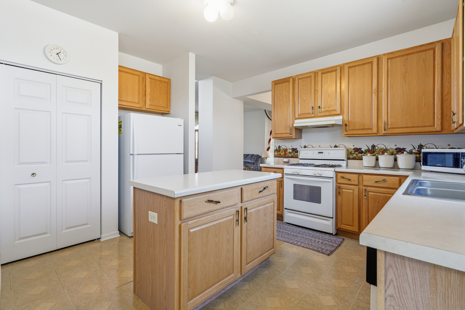 100 Sycamore Drive Bolingbrook, IL 60490 - Photo 10 of 42 a kitchen with a stove top oven sink and cabinets
