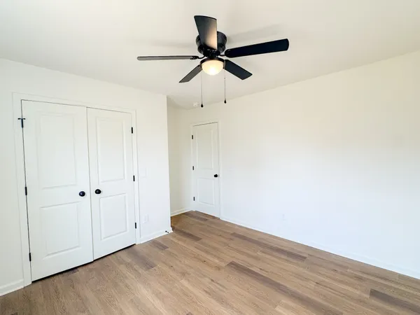 a view of empty room with wooden floor