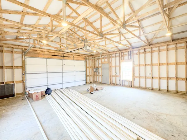 a view of a bedroom with furniture and windows