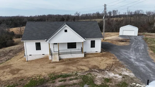 a aerial view of a house with a yard