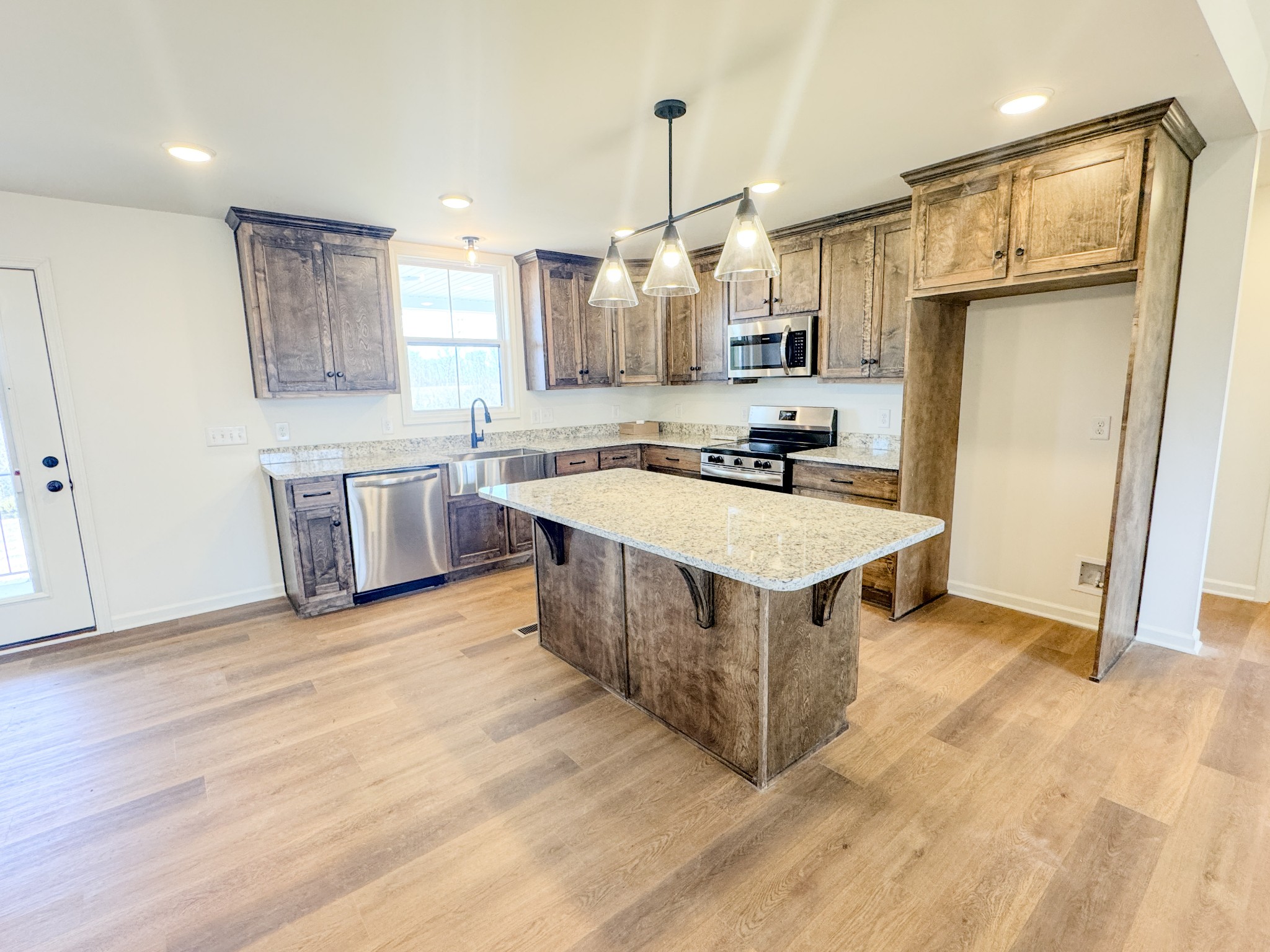 575 Pleasant Hill Road Lafayette, TN 37083 - Photo 10 of 51 a kitchen with stainless steel appliances granite countertop a sink stove and refrigerator