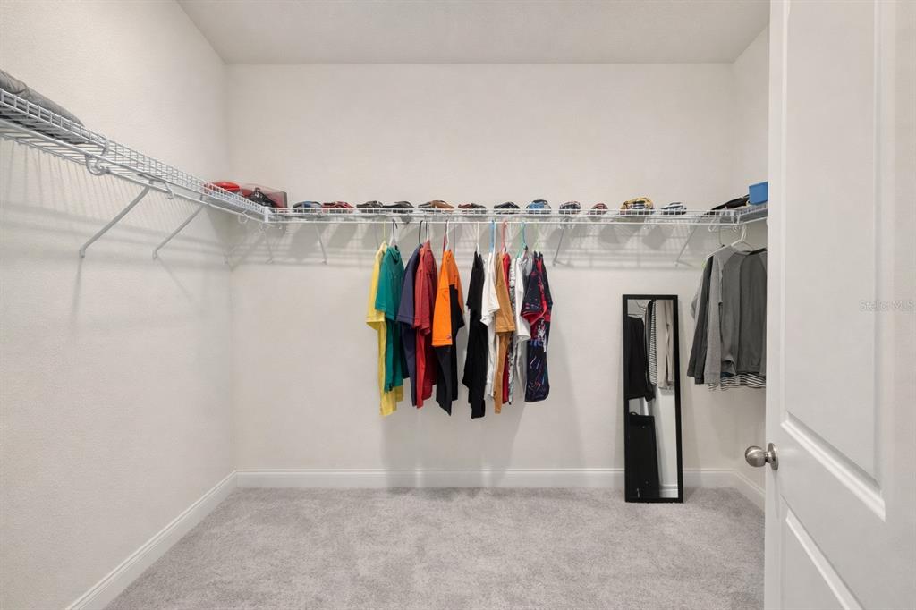 975 Vineyard Rdg Road Minneola, FL 34715 - Photo 11 of 19 a view of walk in closet with clothes and shoes