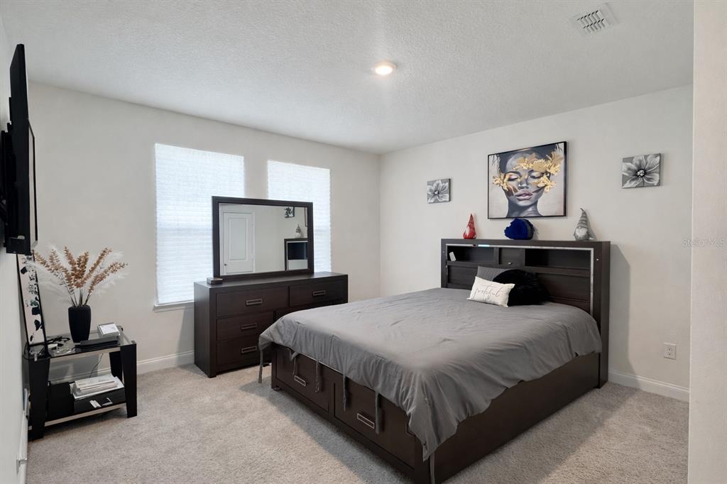 975 Vineyard Rdg Road Minneola, FL 34715 - Photo 16 of 19 a bedroom with a bed and a flat screen tv