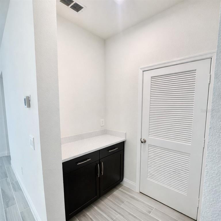 975 Vineyard Rdg Road Minneola, FL 34715 - Photo 17 of 19 a room with a cabinets and wooden floor