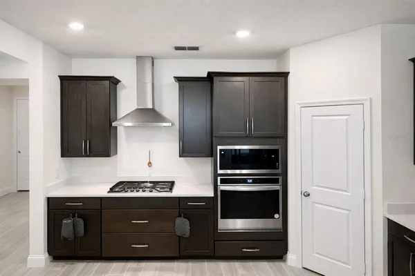 a kitchen with a refrigerator and a stove