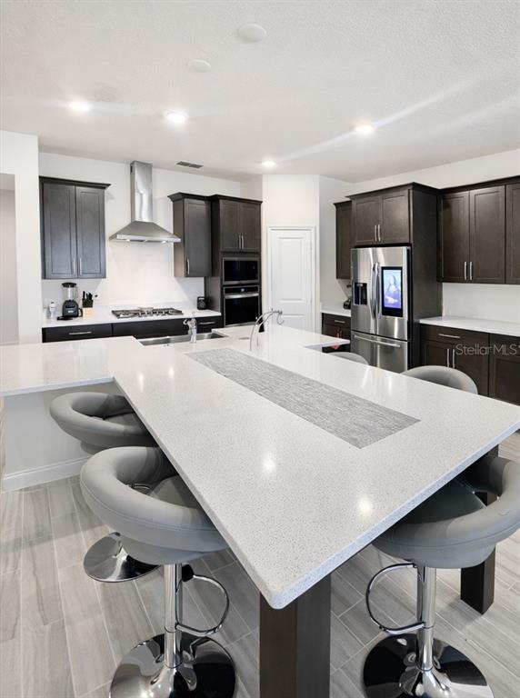 975 Vineyard Rdg Road Minneola, FL 34715 - Photo 7 of 19 a large kitchen with stainless steel appliances a large counter top oven and cabinets