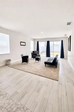 a living room with furniture window and a table