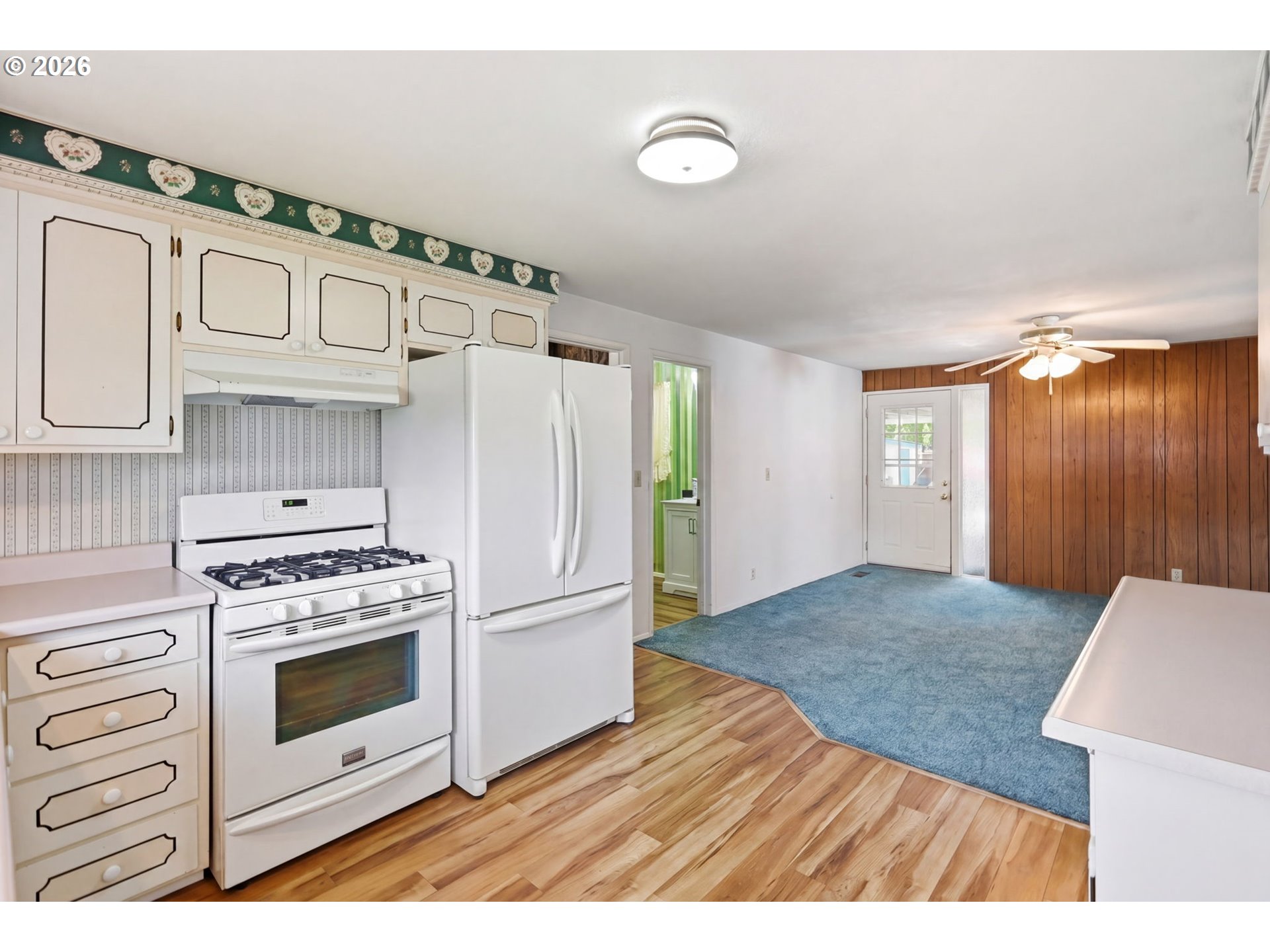2494 38th Street Springfield, OR 97477 - Photo 12 of 38 a kitchen with granite countertop a stove a refrigerator and a wooden floor