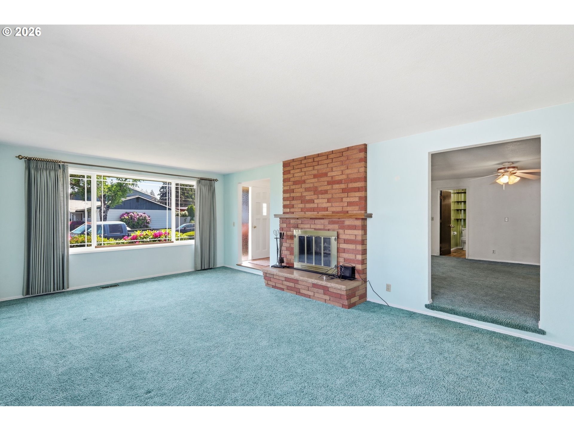 2494 38th Street Springfield, OR 97477 - Photo 6 of 38 a view of an empty room with a fireplace and a window