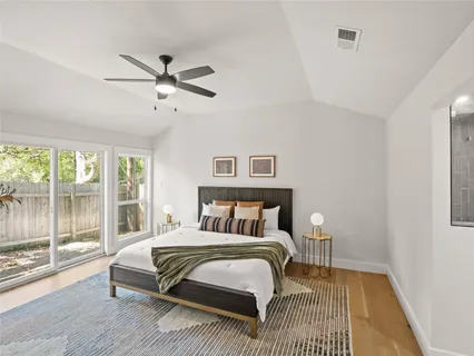 a bedroom with a bed and a night stand