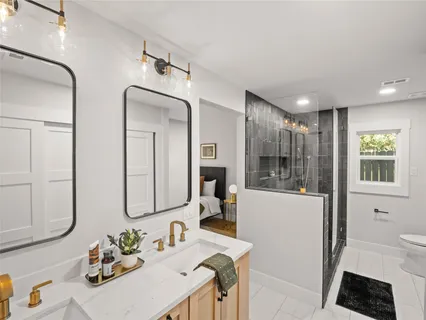 a bathroom with double vanity sink and a mirror