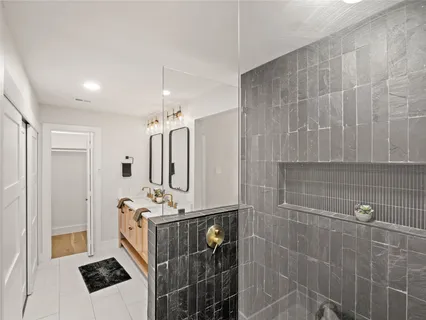a bathroom with pair of shower