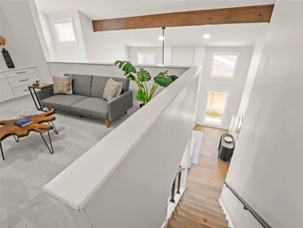 a living room with furniture and a potted plant