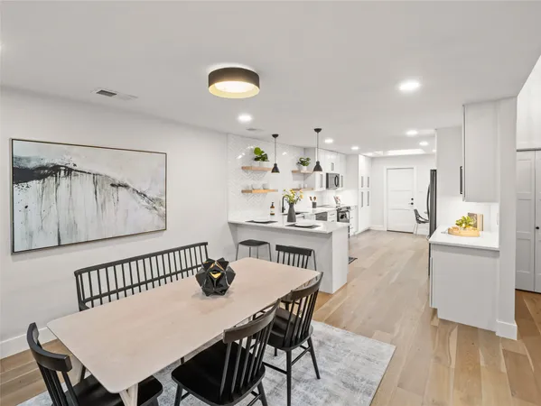 a view of a dining room with furniture and a wooden floor