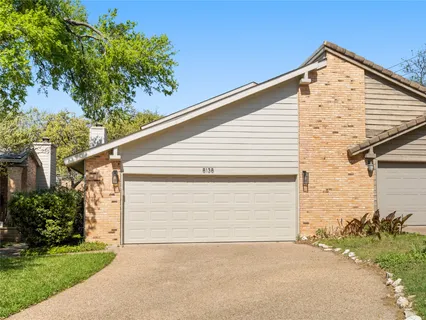 a view of backyard of house with garage
