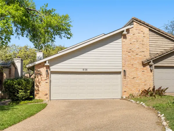 a view of backyard of house with garage