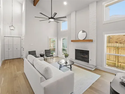 a living room with furniture a fireplace and a window