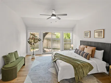 a spacious bedroom with a bed and glass walk in closet