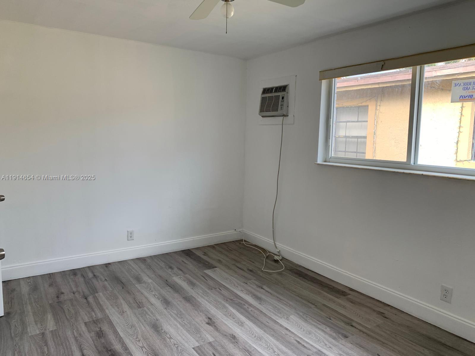 413 Northwest 4th Avenue, Unit 1 Hallandale Beach, FL 33009 - Photo 5 of 7 an empty room with a window