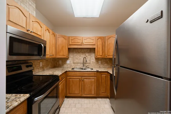 a kitchen with a sink stove and microwave