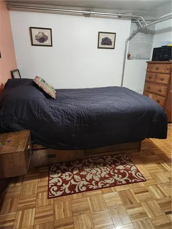 a bed sitting in a bedroom next to a window