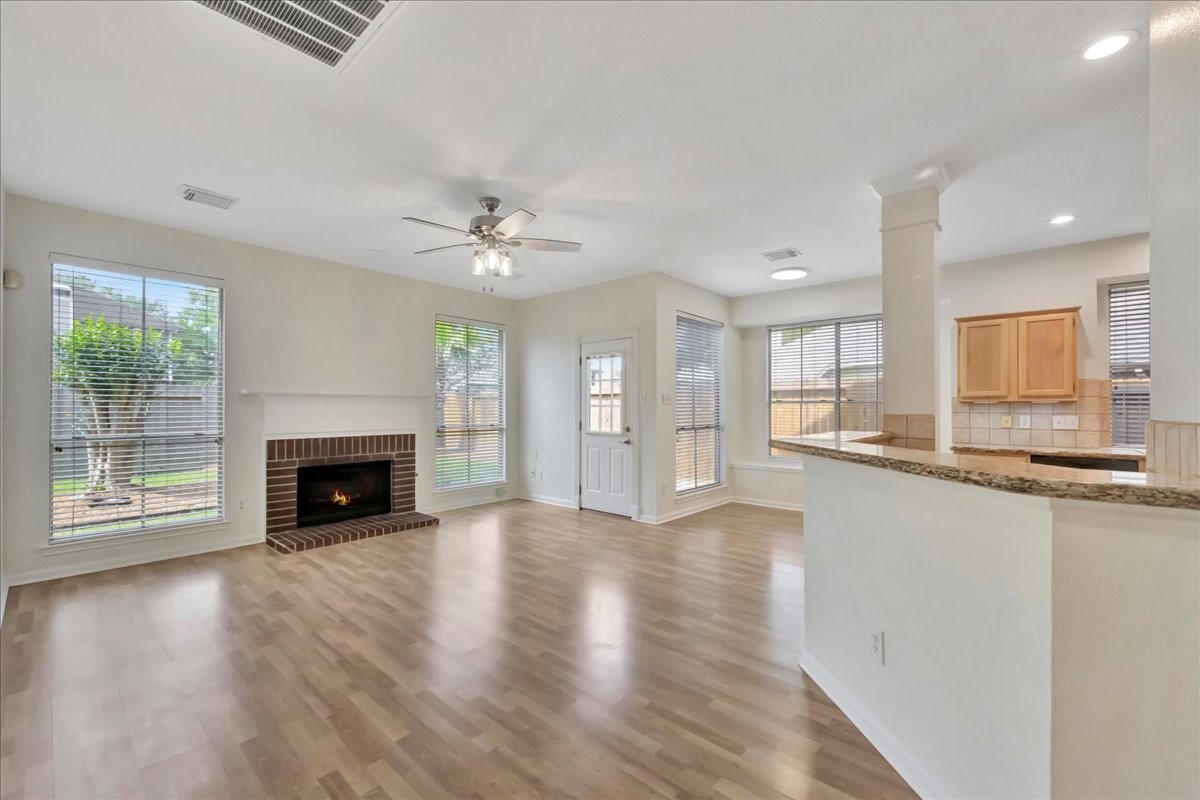 14010 Hazel Ridge Court Houston, TX 77062 - Photo 10 of 38 The family room is open to the kitchen. This part of the house features lots of natural light in addition to modern lighting. Add bar stools at the breakfast bar for added seating.