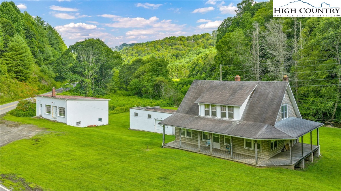 949 Coy Ham Road Lansing, NC 28643 - Photo 1 of 48 a view of a house with pool and a yard