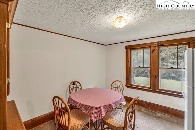 a view of a dining room with furniture and a window