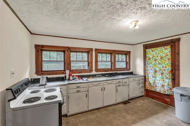 a kitchen that has a sink and a stove