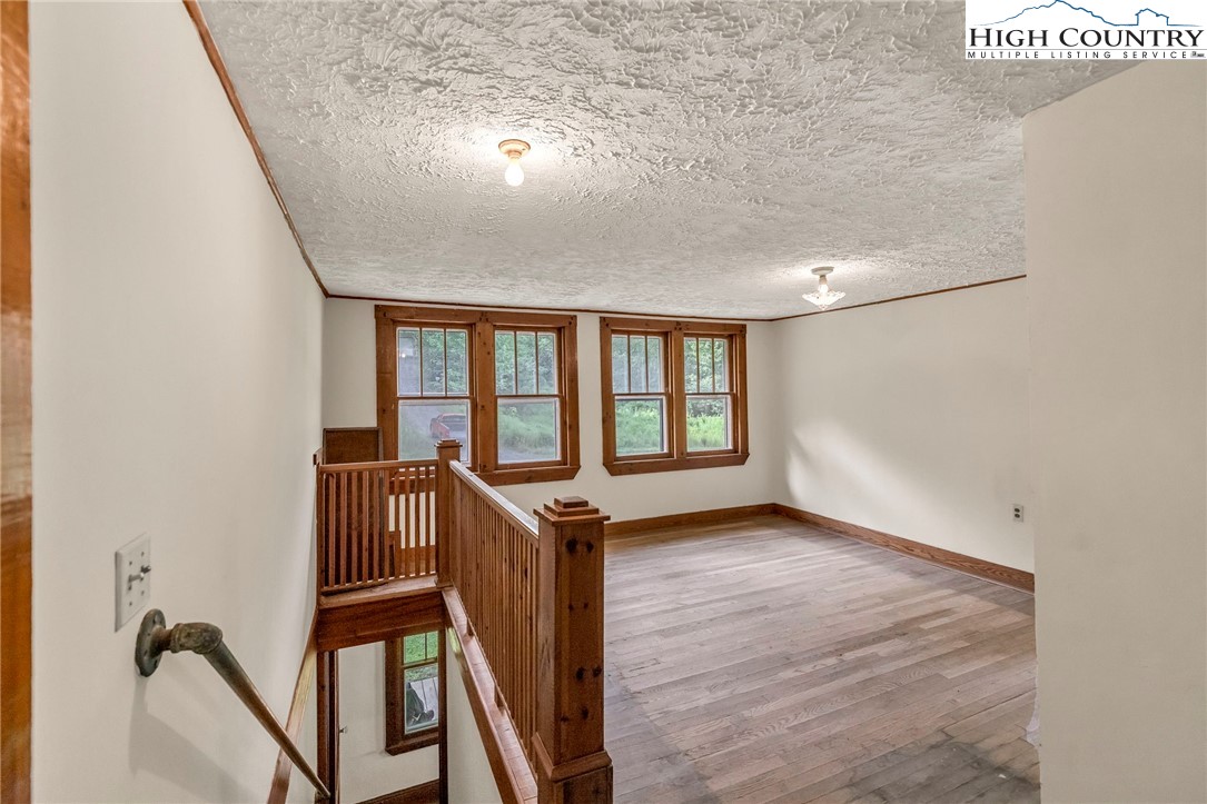 949 Coy Ham Road Lansing, NC 28643 - Photo 31 of 48 wooden floor in an empty room with a window
