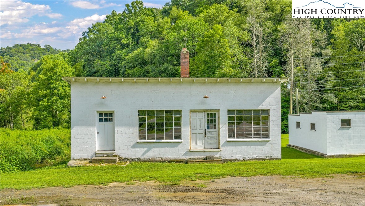 949 Coy Ham Road Lansing, NC 28643 - Photo 37 of 48 a view of a house with a small yard and a large tree