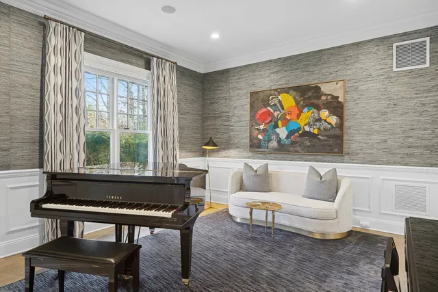 a living room with furniture a rug and a large window