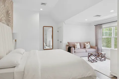 a bedroom with a bed and a large window