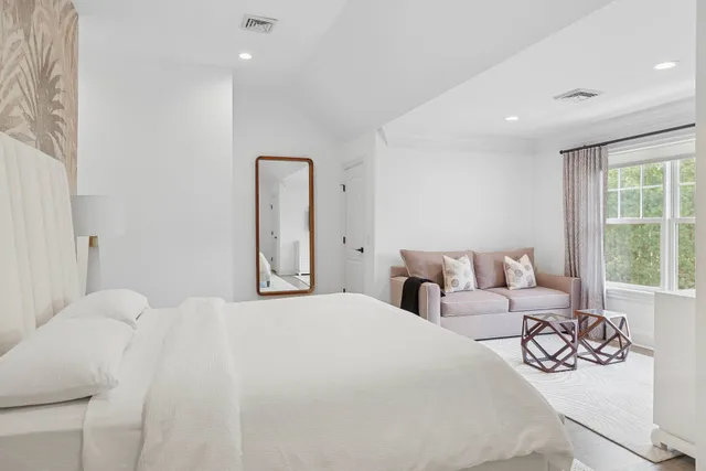 a bedroom with a bed and a large window