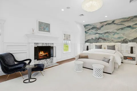 a bedroom with a bed and a fireplace