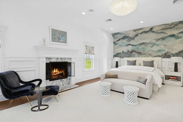 a bedroom with a bed and a fireplace