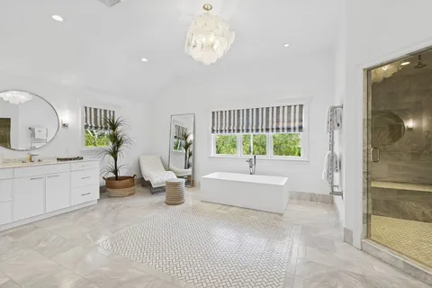 a very nice looking room with a large window and chandelier