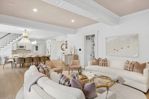 a living room with furniture kitchen view and a table