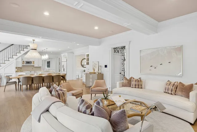 a living room with furniture kitchen view and a table