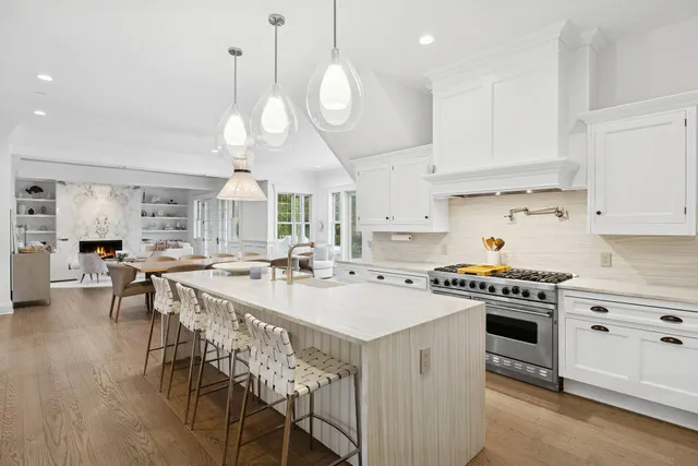 a kitchen with a stove a table and chairs