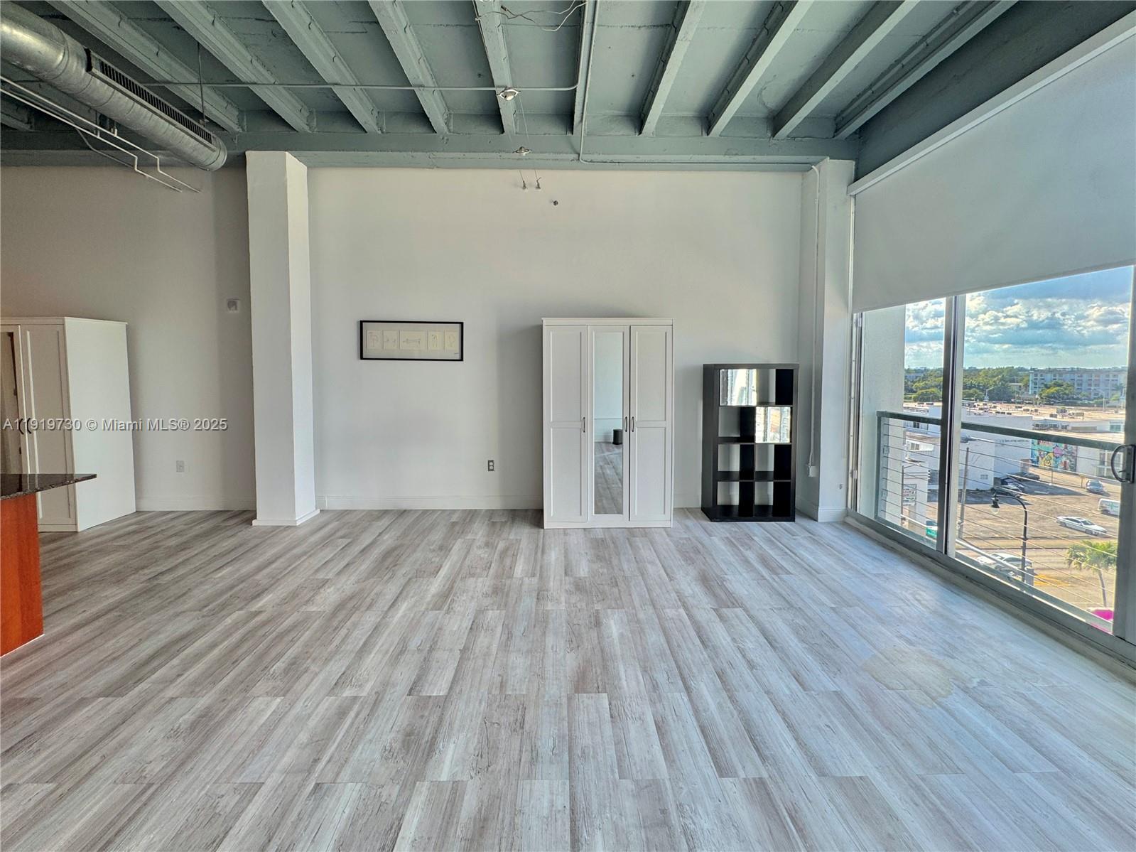 8101 Biscayne Boulevard, Unit R615 Miami, FL 33138 - Photo 13 of 27 a view of empty room with wooden floor and fan