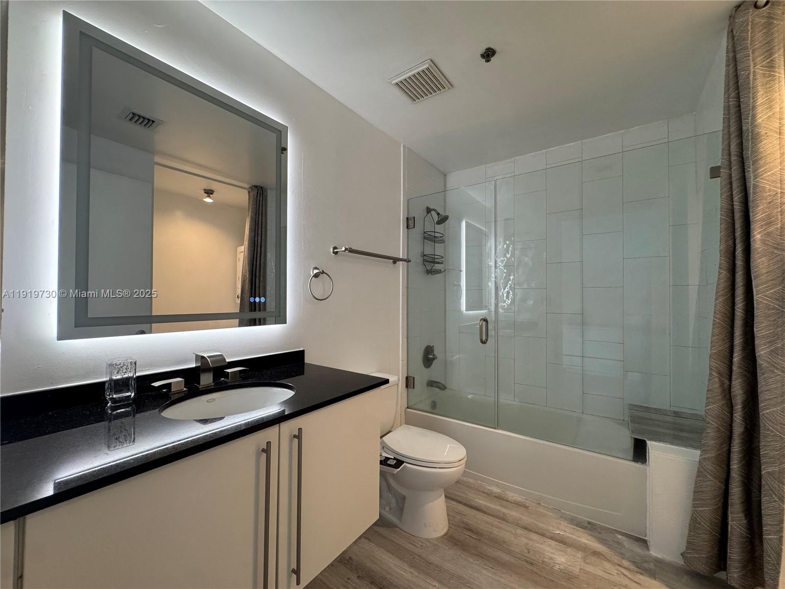 8101 Biscayne Boulevard, Unit R615 Miami, FL 33138 - Photo 16 of 27 a bathroom with a double vanity sink toilet and shower