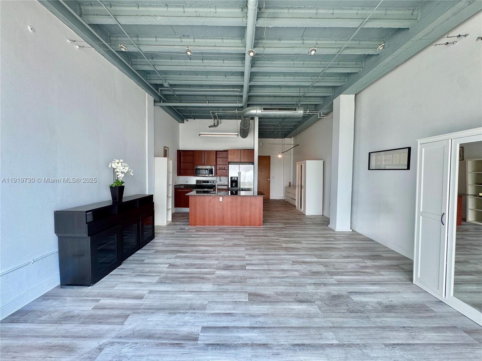 8101 Biscayne Boulevard, Unit R615 Miami, FL 33138 - Photo 6 of 27 a view of kitchen with cabinets and wooden floor