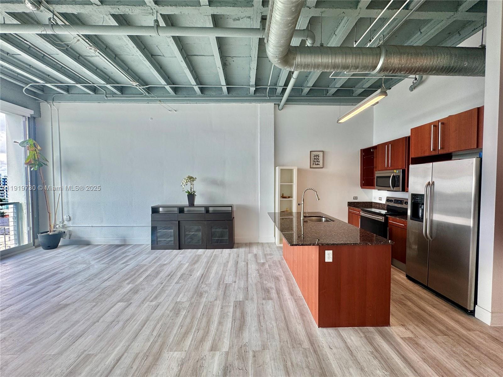 8101 Biscayne Boulevard, Unit R615 Miami, FL 33138 - Photo 7 of 27 a kitchen with stainless steel appliances granite countertop a sink a stove and a refrigerator
